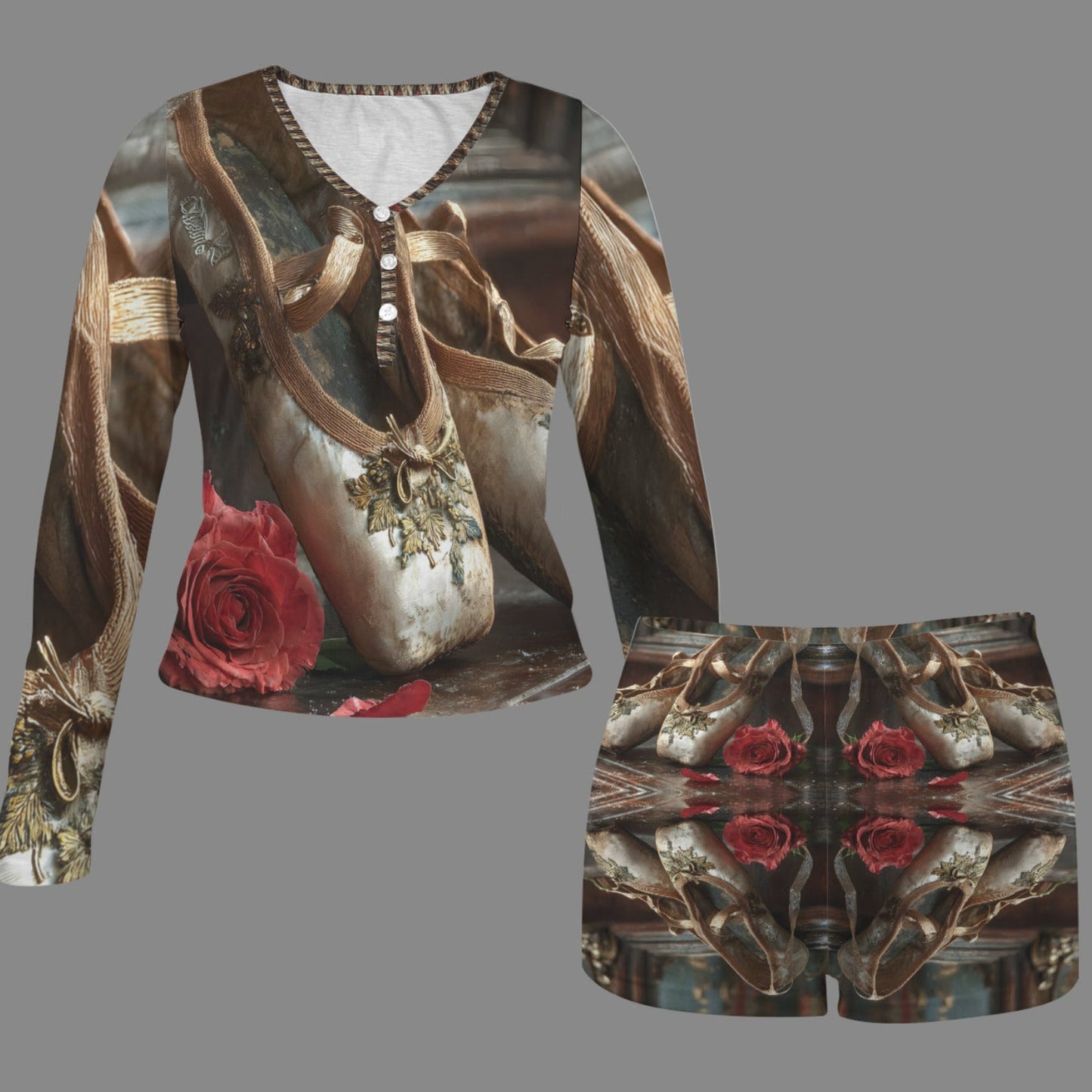 A matching two-piece outfit featuring a long-sleeve top and shorts with an all-over vintage ballet shoe print in muted gold, brown, and gray tones, accented with red roses, shown on a solid gray background.