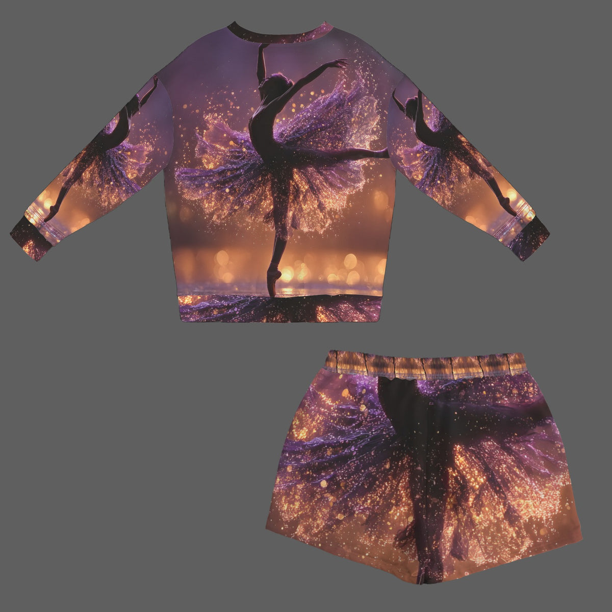 A matching two-piece outfit consisting of a long-sleeve crop top and shorts, both featuring an all-over print of silhouetted ballerina figures against a purple and gold glittery background, displayed on a solid gray background.