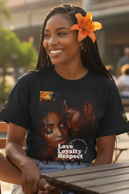 Woman wearing a t-shirt with a graphic design and text, sitting outdoors with a blurred background.