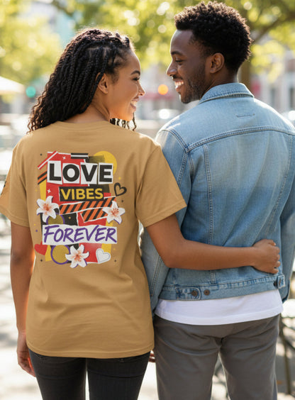 Two people standing together with one wearing a tan shirt with colorful text and graphics.