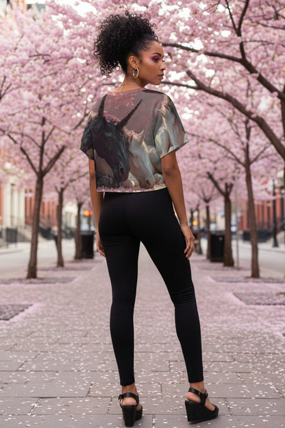 Woman standing under cherry blossom trees in a city setting