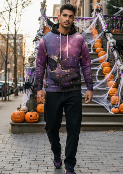 A man walking on a city sidewalk wearing a purple and black galaxy-print hoodie, black pants, and dark sneakers, with Halloween decorations including pumpkins, cobwebs, and skeletons in the background.