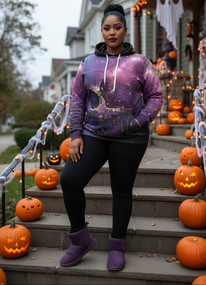 A woman stands on front steps decorated with jack-o'-lanterns and Halloween lights, wearing a purple galaxy-print hoodie, black leggings, and purple UGG boots.