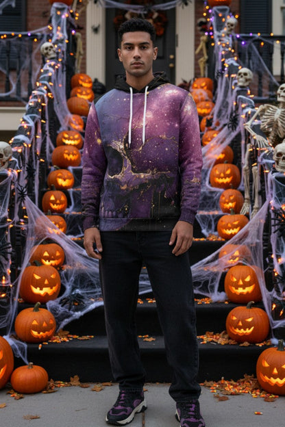 A man stands on a Halloween-decorated front staircase wearing a purple galaxy-print hoodie, black pants, and purple sneakers. The scene includes pumpkins, skeletons, cobwebs, and string lights.