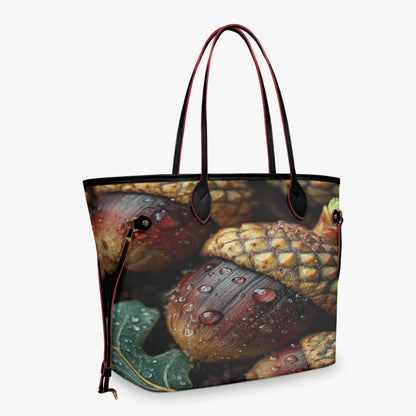 A tote bag featuring a detailed print of acorns and pinecones with water droplets, complete with dark brown handles and trim, shown against a light gray background.
