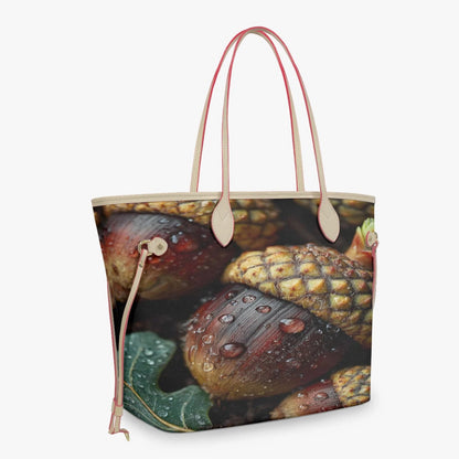 A tote bag featuring a photographic print of wet acorns and leaves, with light beige handles and trim, shown against a plain light gray background.