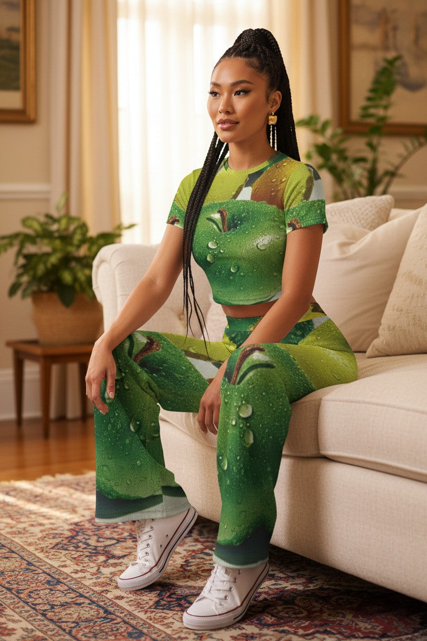 Woman wearing a green apple-themed outfit sitting on a couch in a living room.