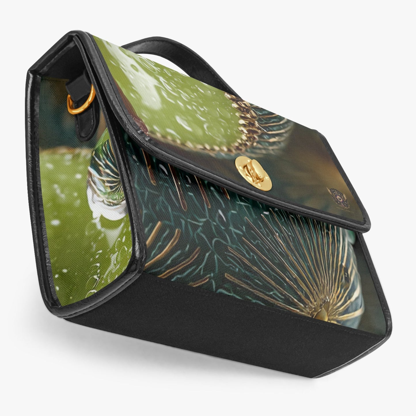 A structured handbag with a glossy green cactus and succulent print on a black base, featuring a gold-tone logo clasp and a top handle, set against a light gray background.