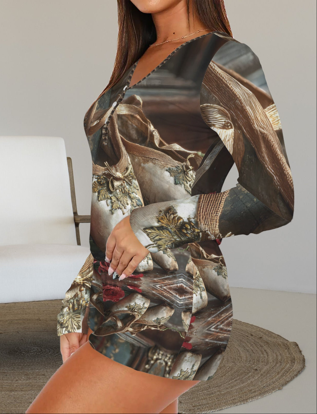 A woman wearing a long-sleeve mini dress with a dark brown and beige abstract print, posed in front of a white armchair in a minimalist room.