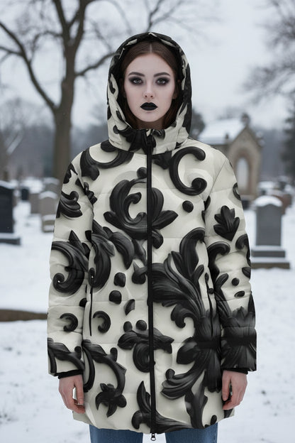 A model wearing a hooded puffer jacket with a black and cream 3D baroque scroll pattern, standing in a snowy cemetery.
