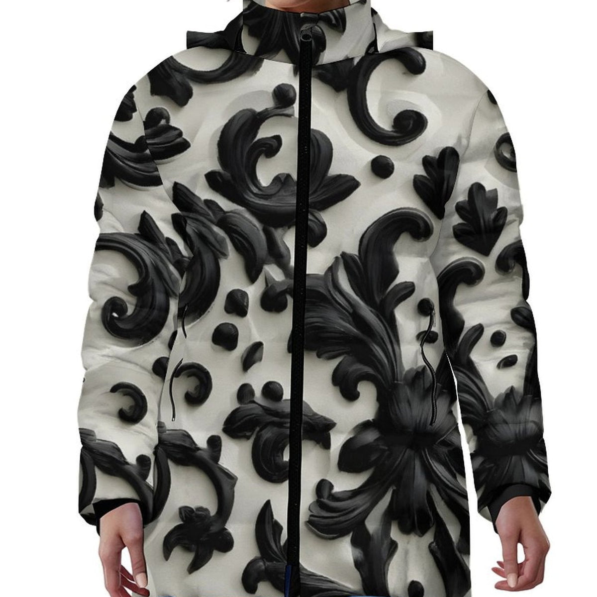 A model wearing a hooded zip-up jacket with a bold black and off-white baroque scroll pattern, paired with blue jeans against a plain white background.