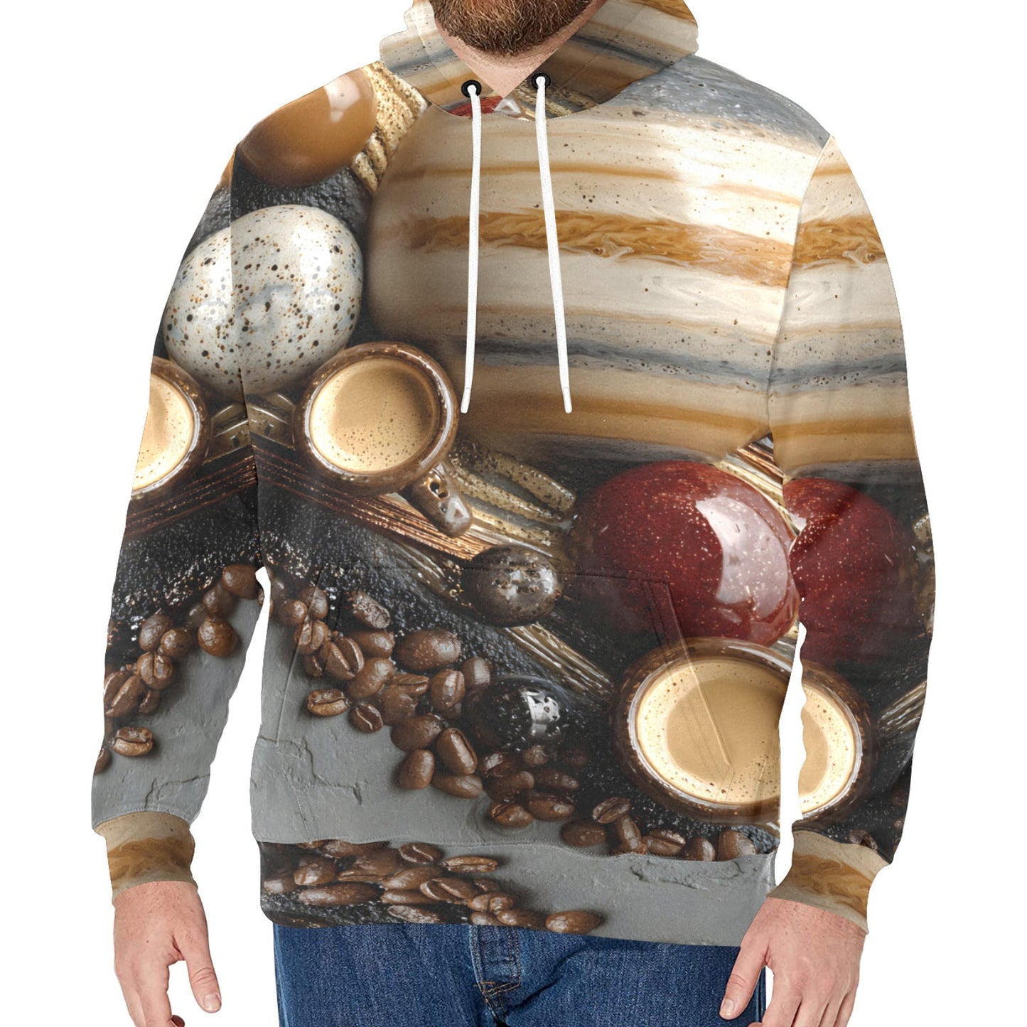 A man wearing a pullover hoodie with an all-over coffee-themed print featuring coffee cups, coffee beans, and a striped background, paired with blue jeans against a plain white background.