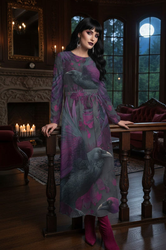 A woman stands indoors in a dark, moody room with windows, candles, and red upholstered furniture, wearing a long-sleeve midi dress with a raven print in purple, gray, and black, paired with magenta boots.