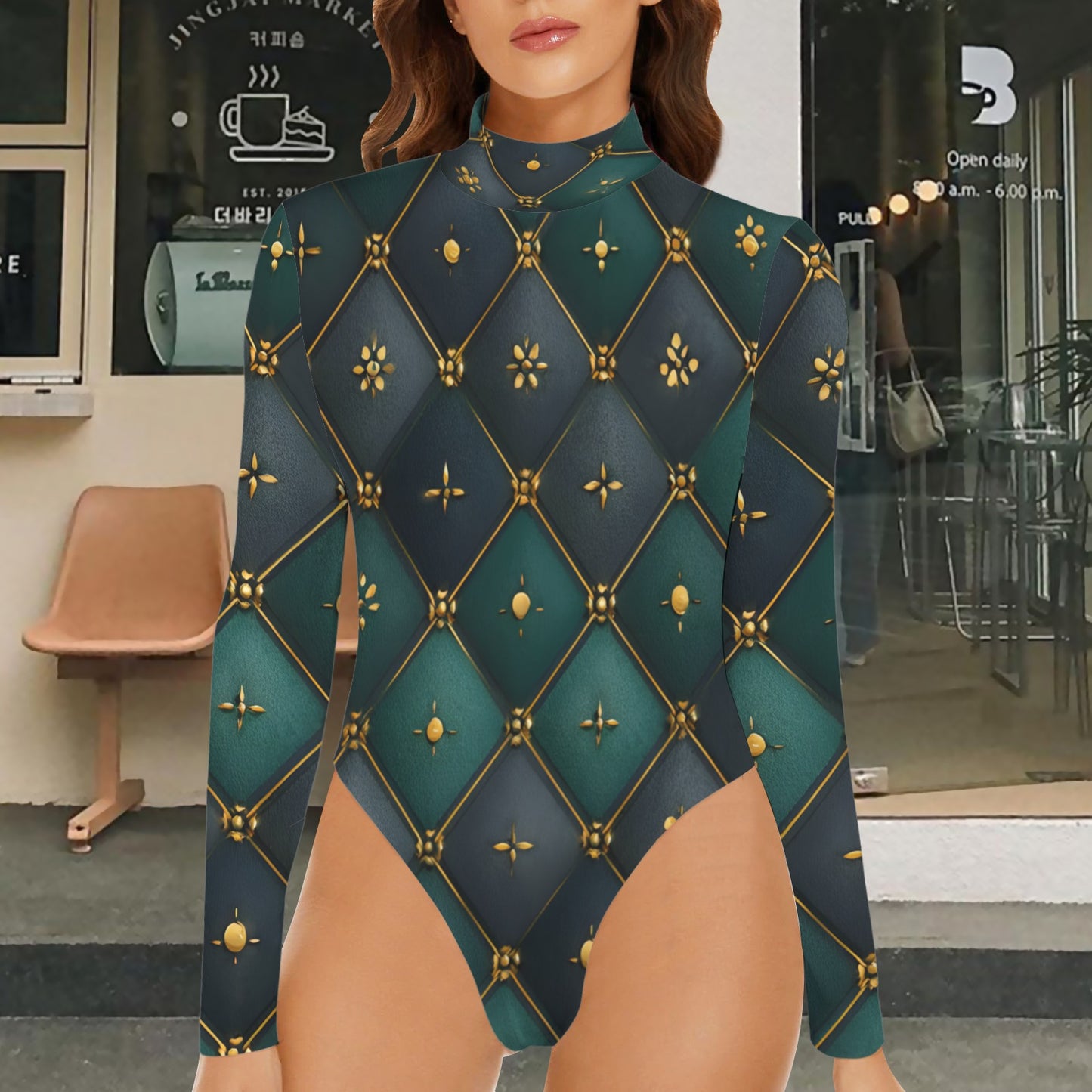A woman wearing a long-sleeve bodysuit with a dark teal and navy geometric diamond pattern outlined in gold, standing in front of a cafe storefront.