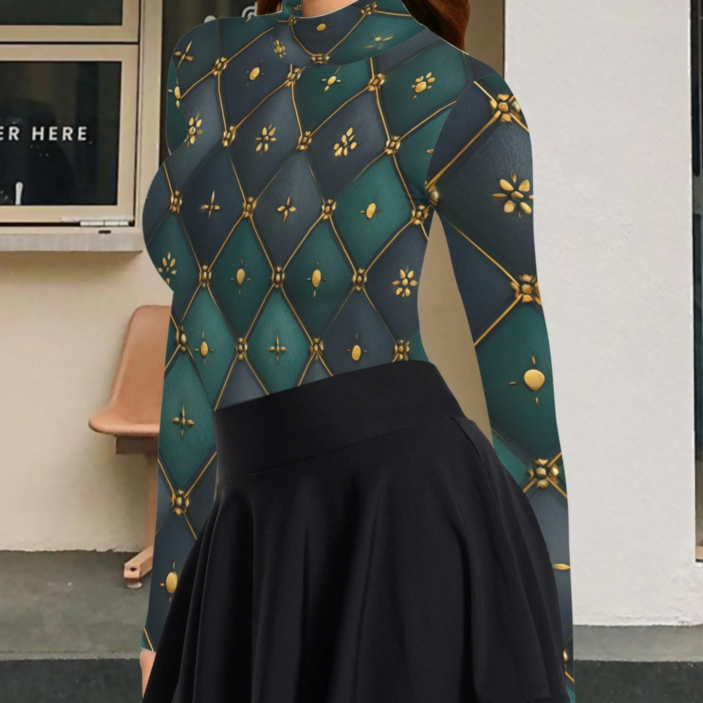 A woman wearing a long-sleeve mock-neck top with a dark teal and black diamond quilted pattern accented with gold lines and motifs, paired with a black pleated mini skirt, standing in front of a building.