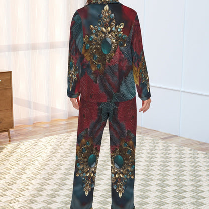A woman stands with her back to the camera wearing a matching long-sleeve pajama set with an ornate jewel-like abstract print in deep red, teal, and gold tones, set in a bright room with a patterned rug.