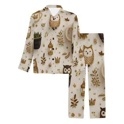 A two-piece pajama set featuring a long-sleeve button-up top and matching pants in an off-white fabric with a whimsical print of brown owls, gold lanterns, potted plants, leaves, and small crowns.