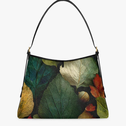 A shoulder bag with a black leather strap and a detailed botanical print of autumn leaves in green, yellow, red, and brown, shown against a plain light gray background.