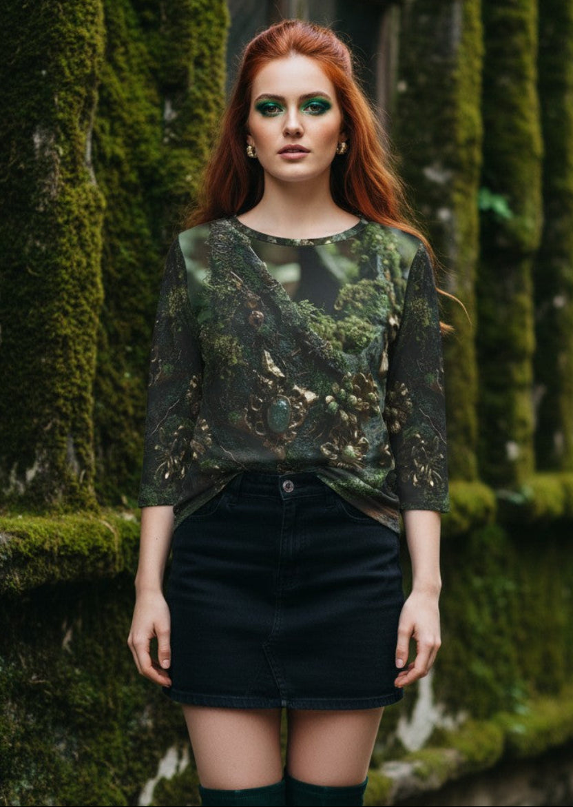 A woman with red hair stands outdoors against a moss-covered stone wall, wearing a sheer green camouflage-patterned top, a black mini skirt, and dark green thigh-high socks.