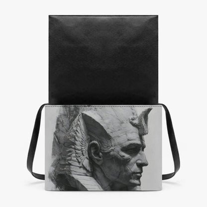 A black shoulder bag with a rectangular black-and-white sculptural bust print on the front, shown against a plain light gray background.