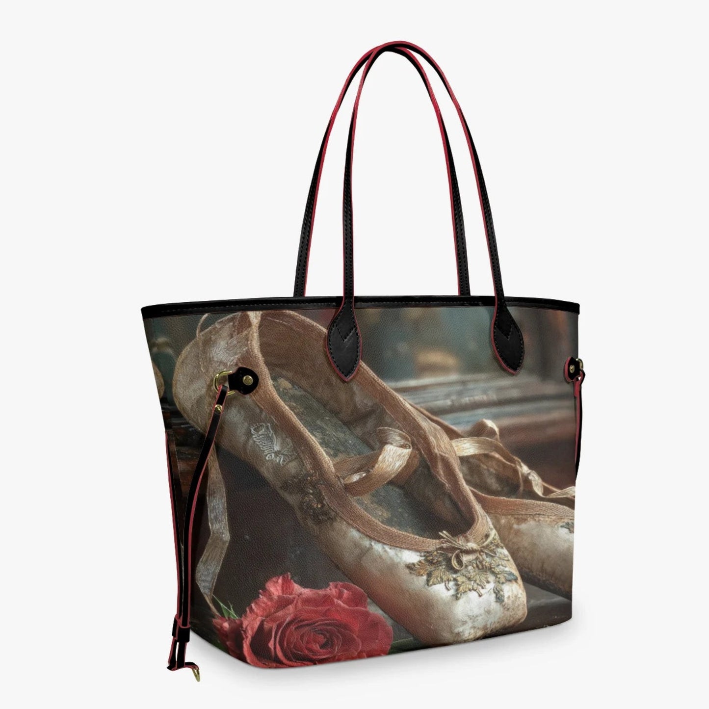 A tote bag featuring a vintage-style print of ballet slippers and a red rose, with dark red handles and trim, shown against a light gray background.