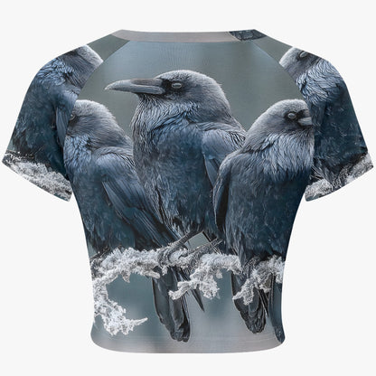 A short-sleeve crop top featuring an all-over graphic print of four black and gray crows perched on frosted branches, shown against a plain white background.