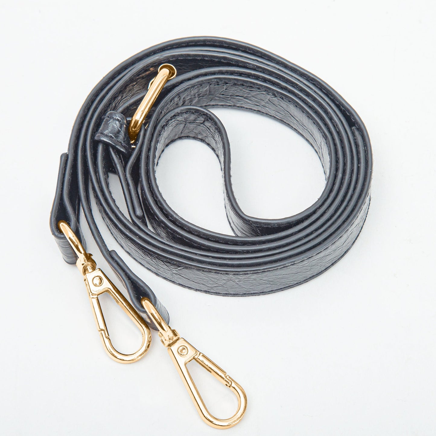 Gray leather dog leash with gold hardware on a white background