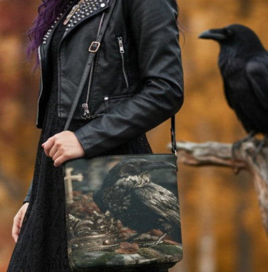 A woman with purple hair stands outdoors in an autumn park wearing a black leather moto jacket, black lace dress, and black combat boots, holding a camouflage patterned shoulder bag. A black raven is perched on a tree branch to her right.