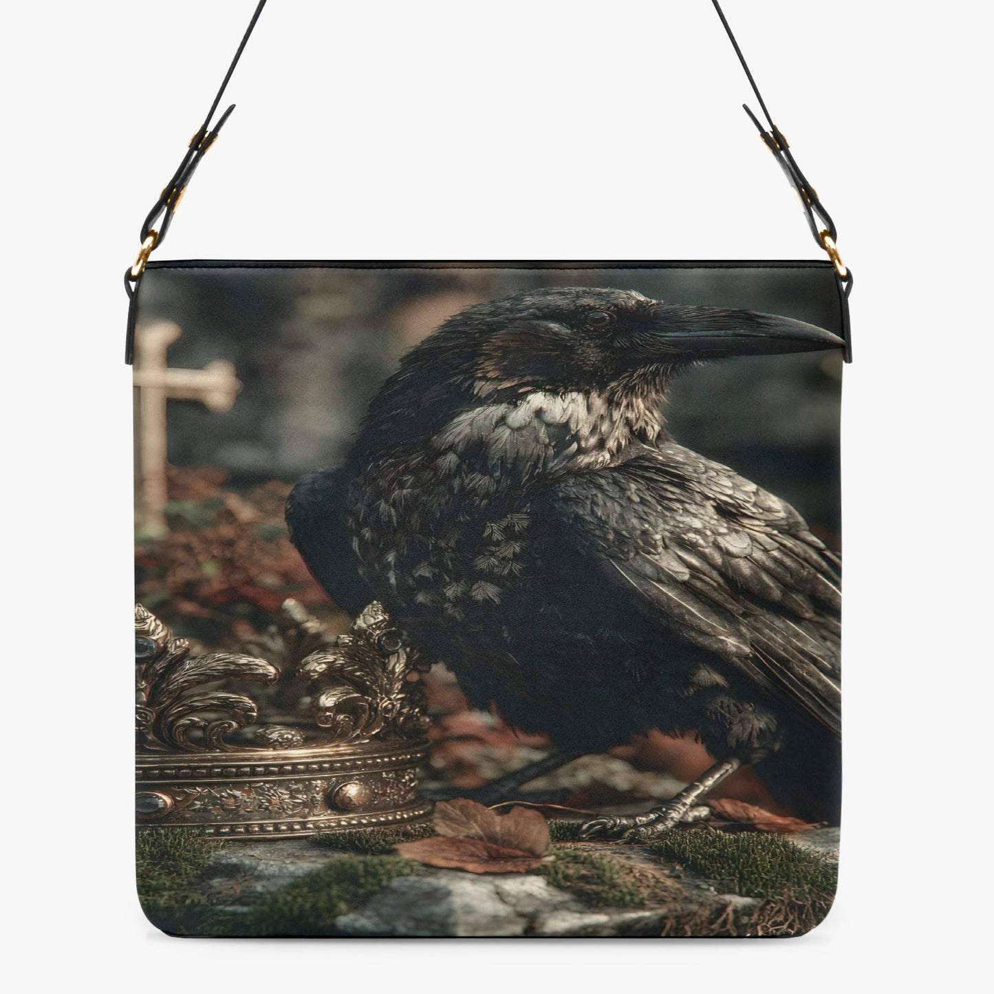 A shoulder bag with a printed design of a raven perched next to an ornate crown, shown against a plain light gray background.