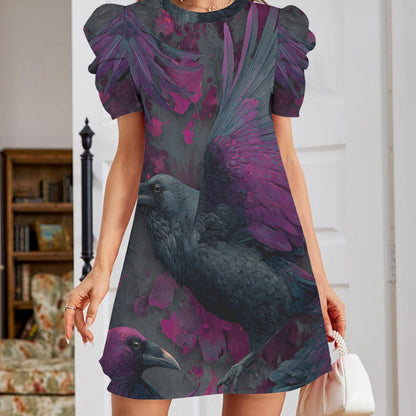 A woman wearing a short-sleeve puff-sleeve dress with a dark raven and purple flower print, holding a small white handbag in an indoor setting.