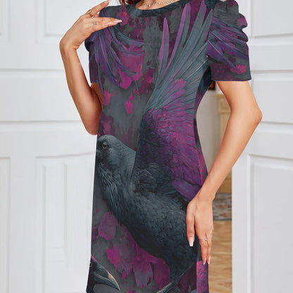 A woman wearing a short-sleeve puff-sleeve dress with a dark gray and purple bird and floral print, standing in front of white paneled doors.