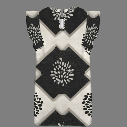 A sleeveless baby dress with a black and off-white geometric pattern featuring diamond and chevron shapes, displayed on a solid gray background.