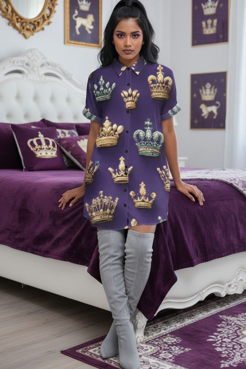 A woman in a button up shirt dress leans on her royal themed bed