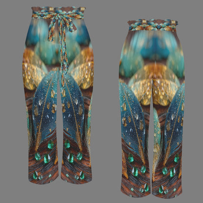 A pair of wide-leg cropped pants shown from the front and back on a plain gray background. The fabric features a detailed print of teal and blue feathers with gold spots and green jewel-like accents, and a braided multicolor drawstring at the waist.