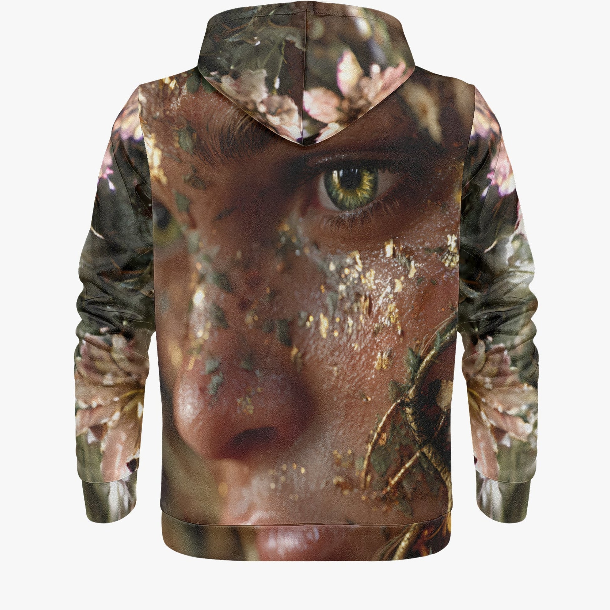 A pullover hoodie shown from the back, featuring an all-over photographic print of a close-up human face with a green eye, overlaid with a camouflage pattern and pink floral elements, on a light gray background.