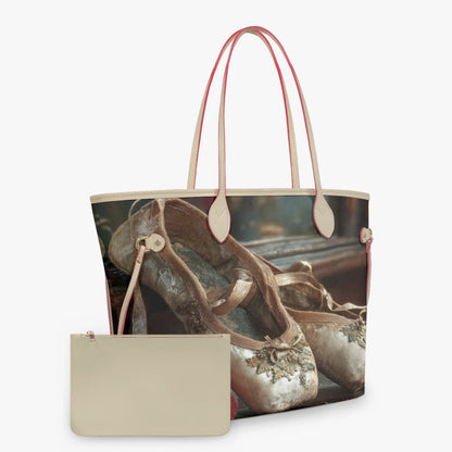 A tote bag with a vintage ballet shoe print and light beige handles, shown alongside a matching beige zip pouch on a light gray background.