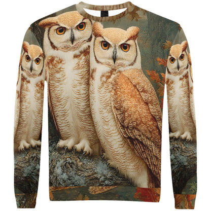 A crewneck sweatshirt featuring a detailed all-over print of four great horned owls in warm brown, beige, and cream tones against a dark, textured background with autumn leaves.